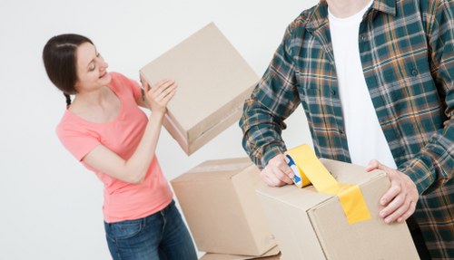 Moving team carrying furniture in a North London flat