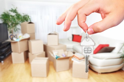 Professional movers carrying furniture in a north London home
