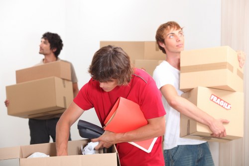 Packed moving boxes and furniture in a Kentish Town property