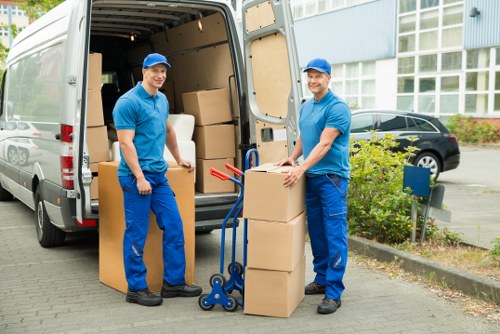 Professional team handling office furniture and boxes during a Kentish Town move