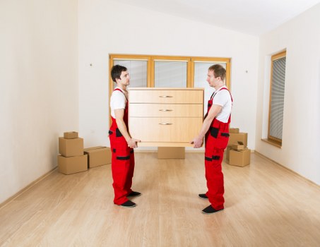 Staff using PPE while handling household items safely
